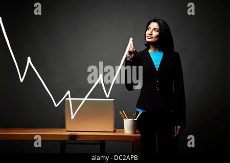 Woman drawing line graph Stock Photo