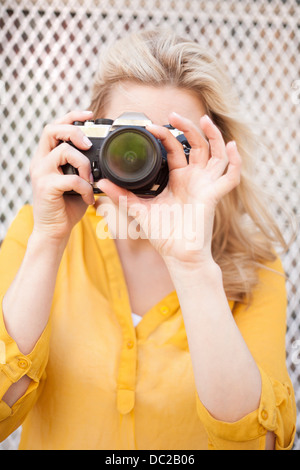 Woman taking photo with camera Stock Photo