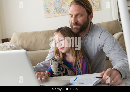 Father with child using laptop Stock Photo