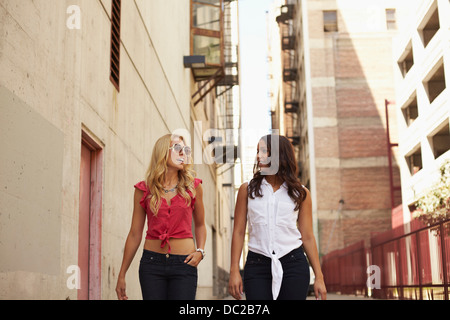 Women walking and chatting on street Stock Photo