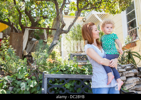 Mother looking at child in arms Stock Photo