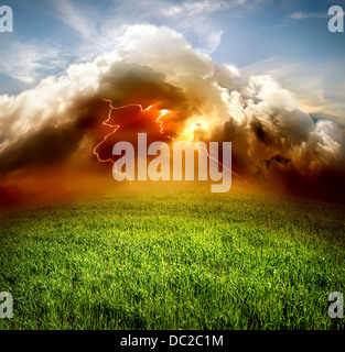 Clouds and lightning in the green field Stock Photo