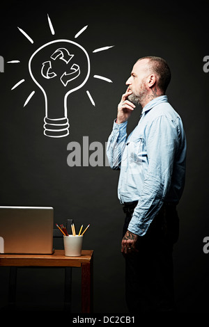 Man contemplating on recycling idea Stock Photo