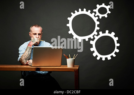 Conceptual image of man as cog in the wheel Stock Photo
