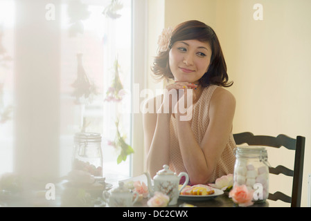 Woman day dreaming at tea time Stock Photo