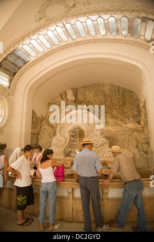 PEOPLE TASTING WATER ART DECO GROTTO OF SOURCE DES CELESTINES VICHY AUVERGNE FRANCE Stock Photo