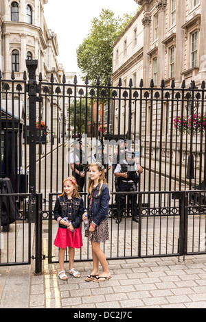 Tourists in front of Number 10 Downing Street Security Gate Stock Photo