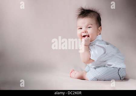 One image from a series of studio photos of a cute mixed race Asian Caucasian baby with wild hair making gorgeous expressions Stock Photo