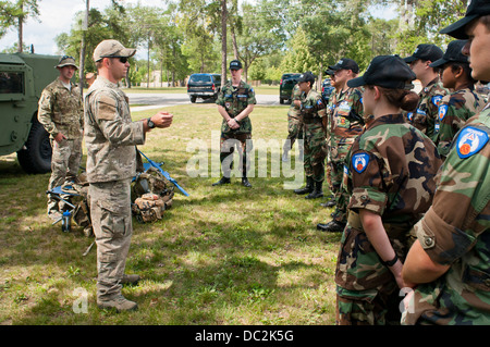 Cadets from the Michigan Wing Civil Air Patrol listen to Joint Tactical Air Controller Staff Sgt. Nathan Hruska from the 182nd Air Support Operations Group talk about his career field near a Humvee at Alpena Combat Readiness Training Center, Mich., Aug. 1 Stock Photo