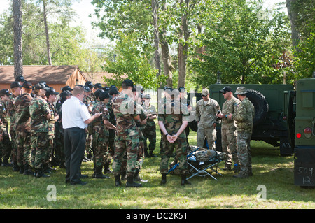 Cadets from the Michigan Wing Civil Air Patrol listen to joint tactical air controllers from the 182nd Air Support Operations Group talk about their career field near a pair of Humvees at Alpena Combat Readiness Training Center, Mich., Aug. 1, 2013. The c Stock Photo