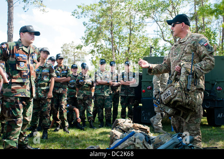 Cadets from the Michigan Wing Civil Air Patrol listen to Joint Tactical Air Controller Master Sgt. Charles Barth from the 182d Air Support Operations Group talk about his career field near a Humvee at Alpena Combat Readiness Training Center, Michigan, Aug Stock Photo