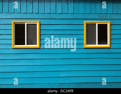 Rustic blue wooden wall with two windows Stock Photo