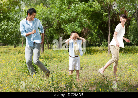 Young family playing hide-and-seek Stock Photo