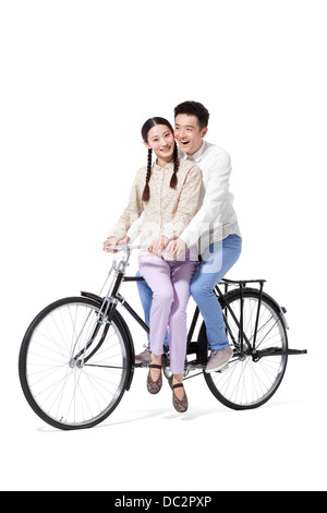 Retro couple riding an old-fashioned bicycle Stock Photo