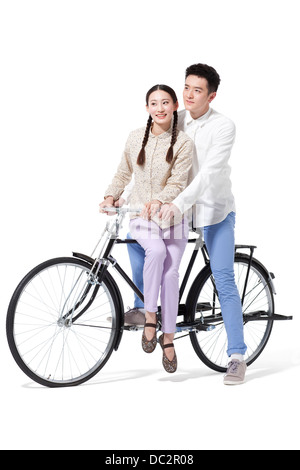 Retro couple riding an old-fashioned bicycle Stock Photo