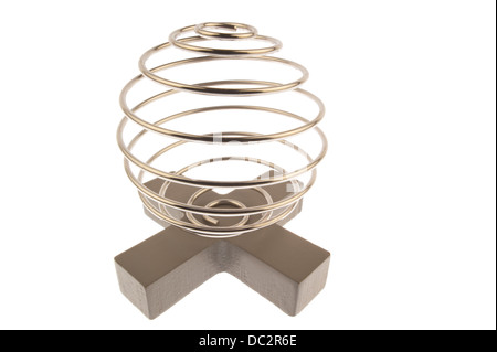 Iron wire tangled up into a spiral ball resulting in a shiny chrome sphere and standing on top of a gray cross and isolated
