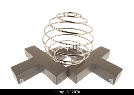 Iron wire tangled up into a spiral ball resulting in a shiny chrome sphere and standing on top of two gray crosses and isolated