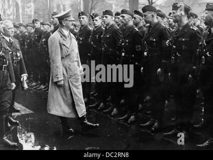 Adolf Hitler walks past the line of uniformed groups of the German Labor Front (DAF) during the Nuremberg Rally in 1937 - the so-called 'Rally of Labor' at Deutsche Hof in Nuremberg, Germany. To the left, head of the German Labour Front Robert Ley. The Nazi Propaganda! on the back of the image reads: 'Nuremberg Rally in 1937. Parade of the uniformed groups at Deutsche Hof: The Führer walk past the front of workers and uniformed groups of the German Labour Front. He talked to different workers and asked about the family situation.' Fotoarchiv für Zeitgeschichte Stock Photo