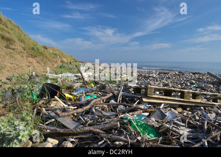 Drift wood and rubbish accumulated on the beach at Kenfig Nature Reserve, South Wales Stock Photo