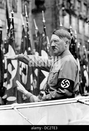 The Nazi Propaganda! image shows Adolf Hitler saluting members of the SA, SS, NSKK, and NSFK, which march past him during the Nuremberg Rally in Nuremberg, Germany, from 6 - 13 September 1937. Fotoarchiv für Zeitgeschichte Stock Photo