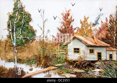 Autumn forest landscape with a rustic house is made of dry grass and twigs. Handmade simple village art concept Stock Photo