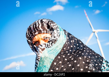 An image of muslim girl and windturbine in the background Stock Photo