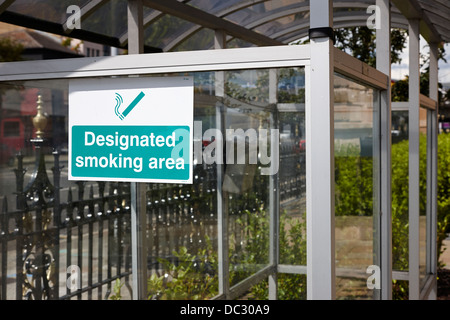 designated smoking area shelter outside an office building in the UK Stock Photo