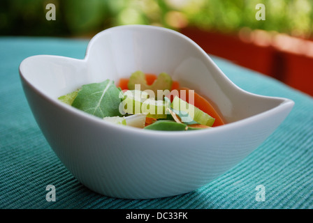 Various vegetables salad in heart shape bowl on green natural background Stock Photo