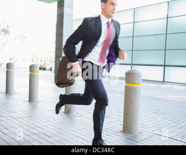 Businessman with briefcase running Stock Photo