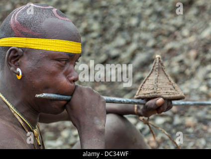 Bodi Tribe Blowing In A Local Trumpet For Kael Ceremony, Hana Mursi, Omo Valley, Ethiopia Stock Photo