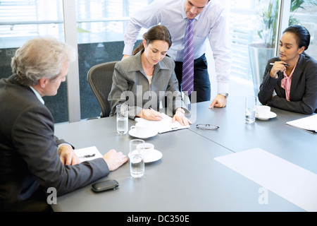 Business people reviewing paperwork in meeting Stock Photo