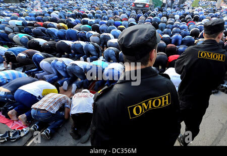 August 8, 2013 - St. Petersburg, Russia - Police watch over muslims praying in the street near Saint Petersburg's main mosque, marking the end of Ramadan and the beginning of Eid al-Fitr (Uraza-Bayram) celebrations. (Credit Image: © Andrey Pronin/ZUMA Wire) Stock Photo