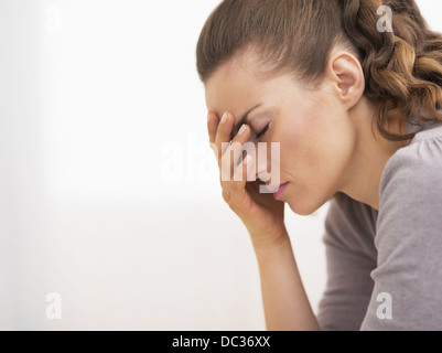 Closeup on pills pack in hand of ill young woman laying on sofa Stock Photo