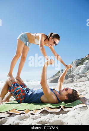 Playful couple on beach Stock Photo
