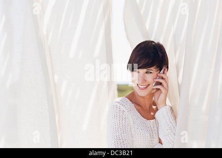 Smiling woman talking on cell phone Stock Photo