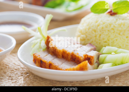 Siu Yuk or crispy roasted belly pork Chinese style, served with steamed rice. Singapore Chinese cuisines. Stock Photo