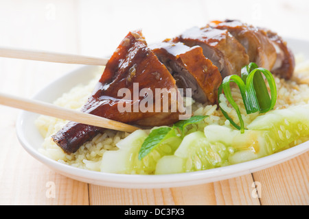 Roasted duck, Chinese style, served with steamed rice on dining table. Malaysia cuisine. Stock Photo