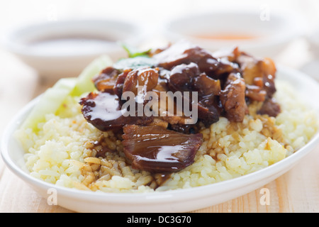 Slices of traditional Chinese marinated barbecue pork on dining table. Bbq pork Char Siew Rice Singapore cuisine. Stock Photo