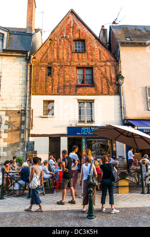 Early evening diners and drinkers outside a historic old wine cave in the town of Amboise, in the Indre-et-Loire department in central France. Stock Photo