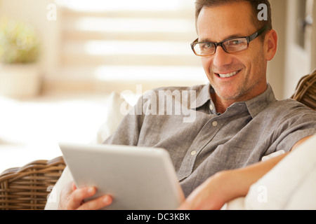 Portrait of smiling man using digital tablet Stock Photo