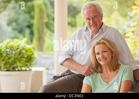 Portrait of smiling couple on porch Stock Photo