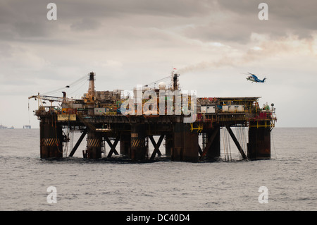 Offshore oil rig Petrobras VIII with helicopter landed/landing on deck, offshore Rio de Janeiro, campos Basin, Brazil Stock Photo