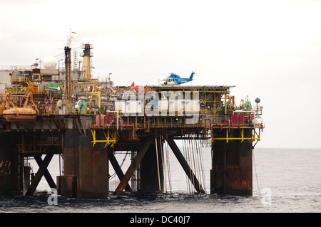 Offshore oil rig Petrobras VIII with helicopter landed/landing on deck, offshore Rio de Janeiro, campos Basin, Brazil Stock Photo