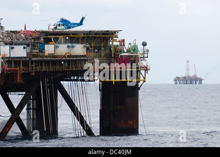 Offshore oil rig Petrobras VIII with helicopter landed/landing on deck, offshore Rio de Janeiro, campos Basin, Brazil Stock Photo