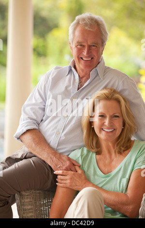 Portrait of smiling couple holding hands on patio