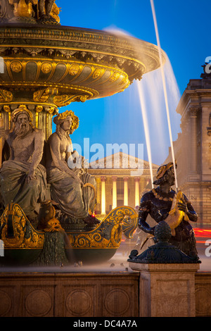 Fontaine des Fleuves - Fountain of Rivers at Place de la Concorde with L'église Sainte-Marie-Madeleine beyond, Paris France Stock Photo