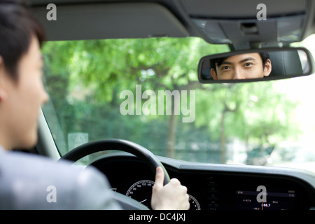 Diver looking at rear view mirror Stock Photo