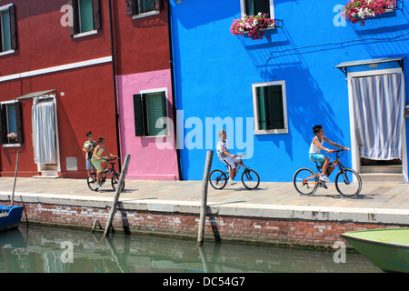 Kids by bike on Burano Island, Isola di Burano Island Stock Photo