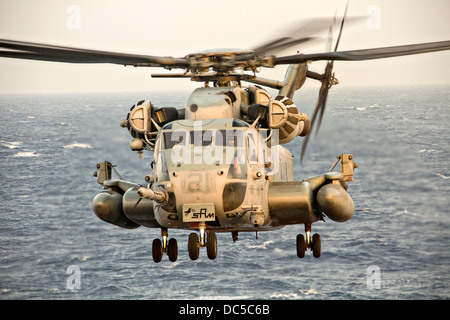 A US Marine Corps CH-53E Super Stallion helicopter prepares to land on the flight deck of the USS San Antonio July 19, 2013 in the Arabian Sea. Stock Photo