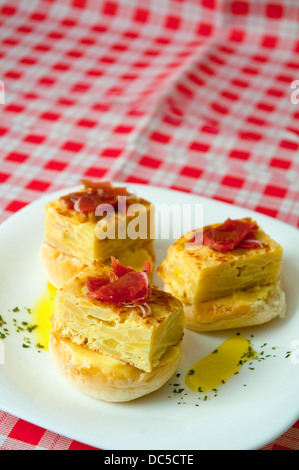 Spanish tapa: Spanish omelet with Iberian loin. Stock Photo